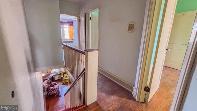 stairs featuring baseboards and wood finished floors