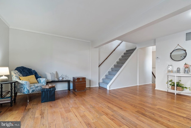 sitting room featuring baseboards, visible vents, and wood finished floors