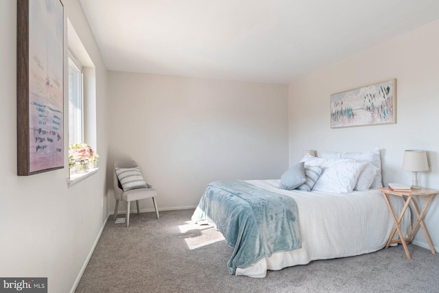 carpeted bedroom featuring baseboards