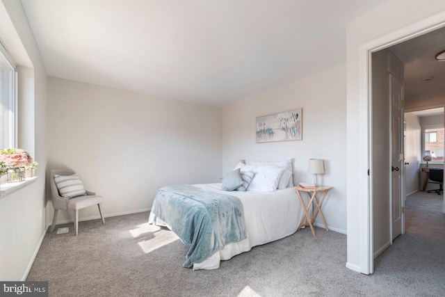 carpeted bedroom featuring baseboards