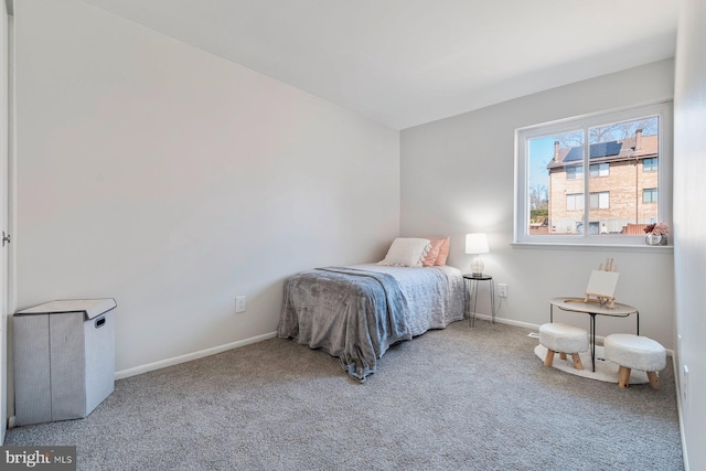 carpeted bedroom featuring baseboards