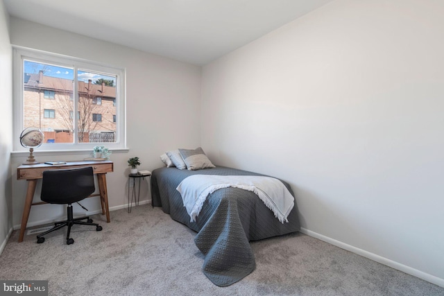 carpeted bedroom featuring baseboards