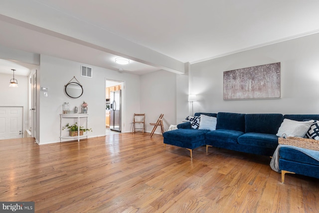 living room featuring light wood-type flooring and visible vents