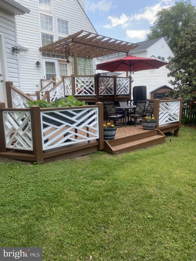 wooden deck with a lawn and a pergola