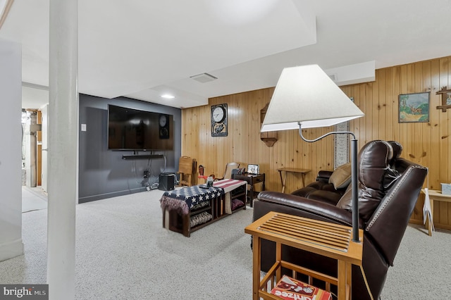 living room with wood walls and visible vents