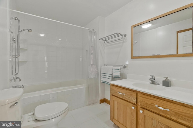 full bath with vanity, tiled shower / bath, toilet, and tile patterned floors