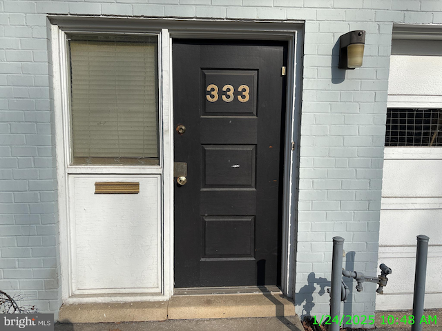 entrance to property with brick siding