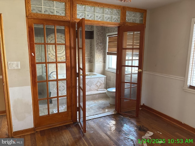 doorway to outside featuring dark wood-type flooring and baseboards