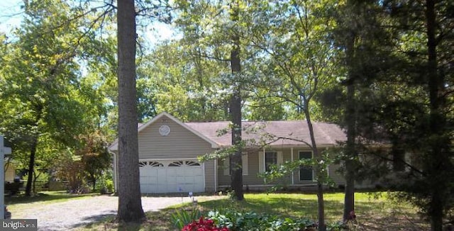 ranch-style house with a garage and driveway