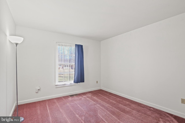 spare room with visible vents, baseboards, and carpet flooring