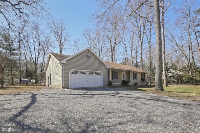 view of front of house featuring a front lawn, an attached garage, and driveway