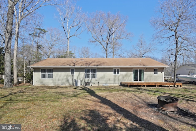 rear view of house featuring crawl space, a lawn, and a wooden deck