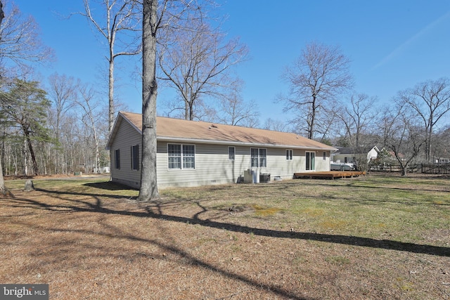 rear view of house with a deck, fence, cooling unit, a yard, and crawl space