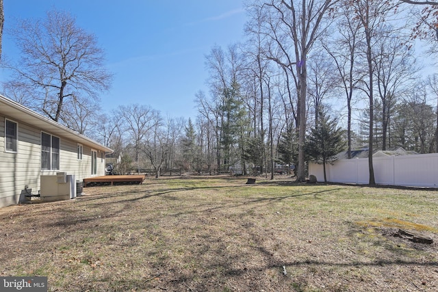 view of yard featuring a deck and fence