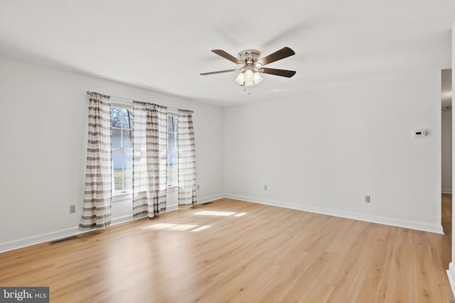 unfurnished room featuring ceiling fan, baseboards, and light wood-style flooring