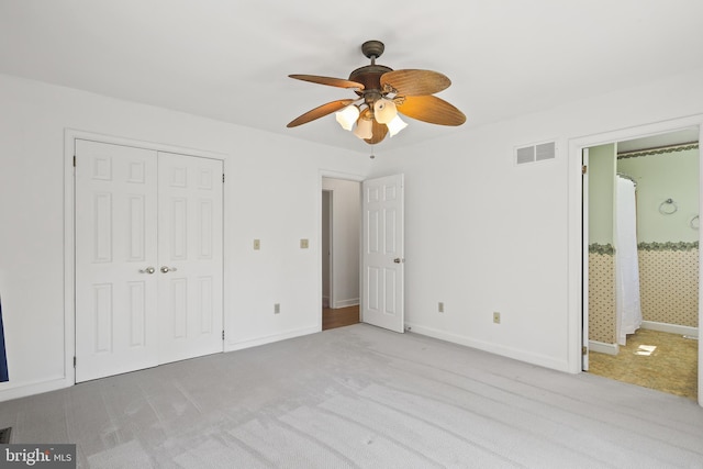 unfurnished bedroom with visible vents, baseboards, carpet floors, a closet, and a ceiling fan