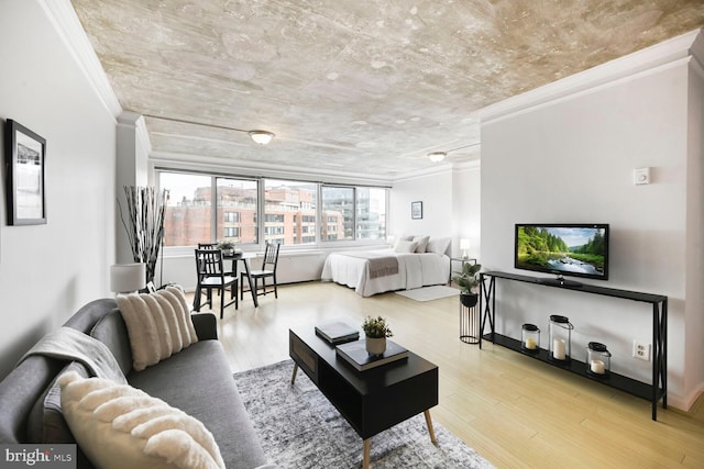 bedroom with baseboards, wood finished floors, and crown molding