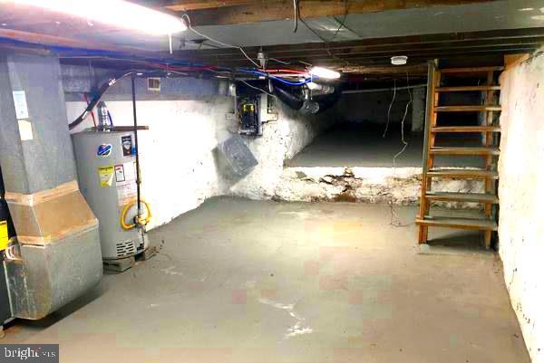 unfinished basement featuring water heater