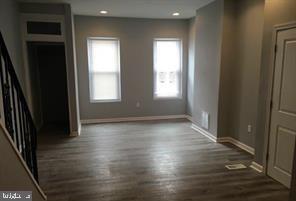 entryway with stairway, baseboards, wood finished floors, and recessed lighting