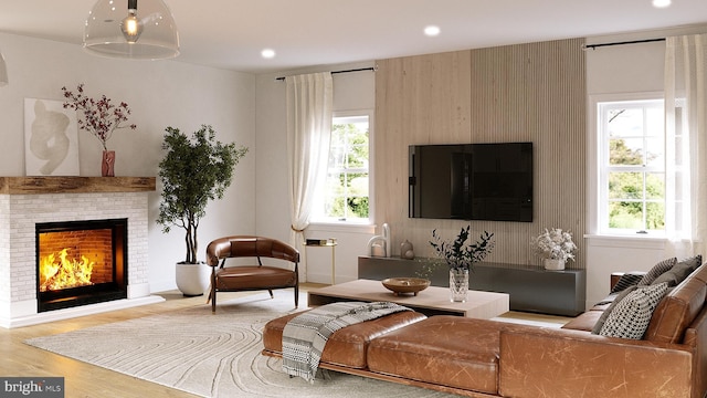 living area featuring a fireplace, wood finished floors, and recessed lighting