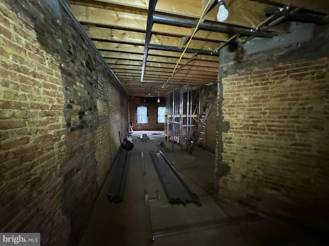 below grade area featuring brick wall