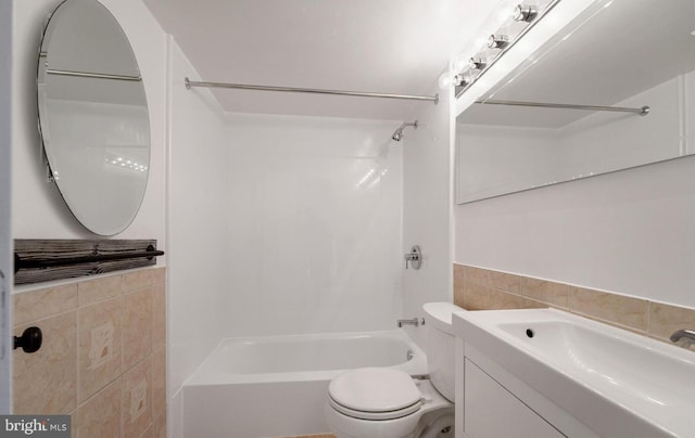 full bathroom featuring toilet, shower / bath combination, vanity, and tile walls