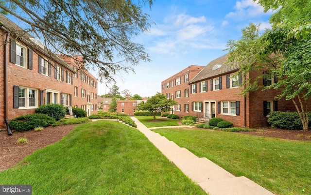 view of home's community featuring a residential view and a lawn