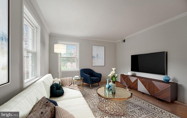 living room featuring wood finished floors, visible vents, and crown molding