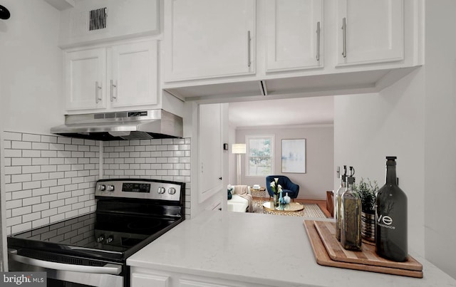 kitchen featuring stainless steel electric stove, decorative backsplash, white cabinetry, and under cabinet range hood