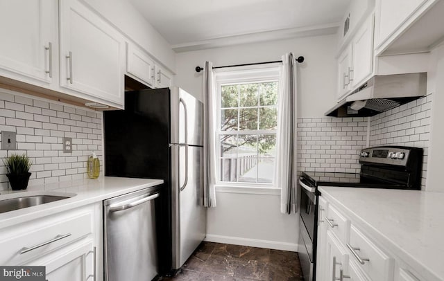 kitchen with stainless steel appliances, tasteful backsplash, white cabinets, under cabinet range hood, and baseboards