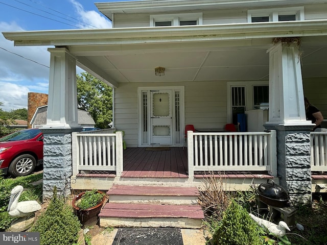 property entrance featuring covered porch