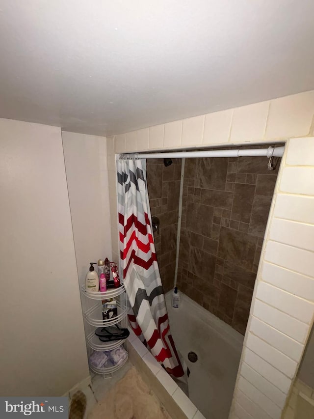 full bathroom with a shower stall and tile patterned floors