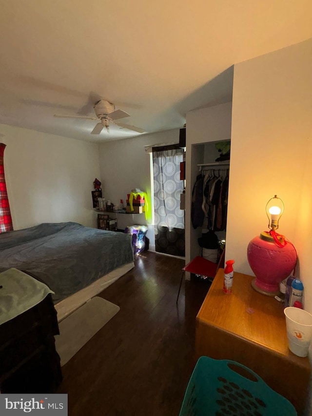 bedroom with a closet, a ceiling fan, and wood finished floors