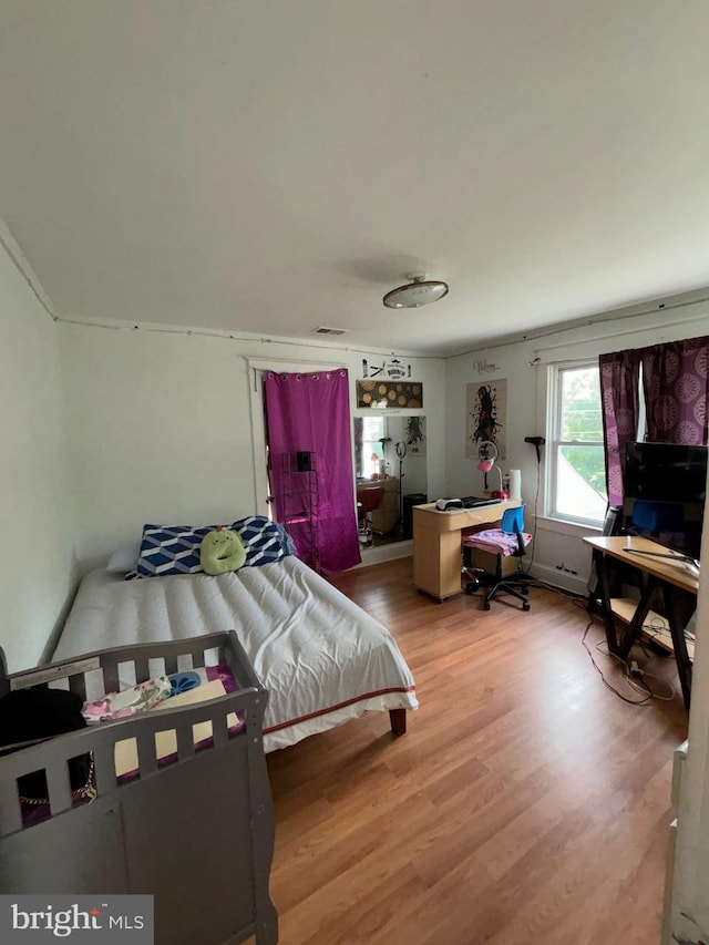 bedroom with wood finished floors