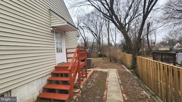 view of yard with fence and central AC