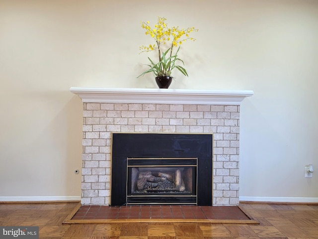 details with a brick fireplace and baseboards