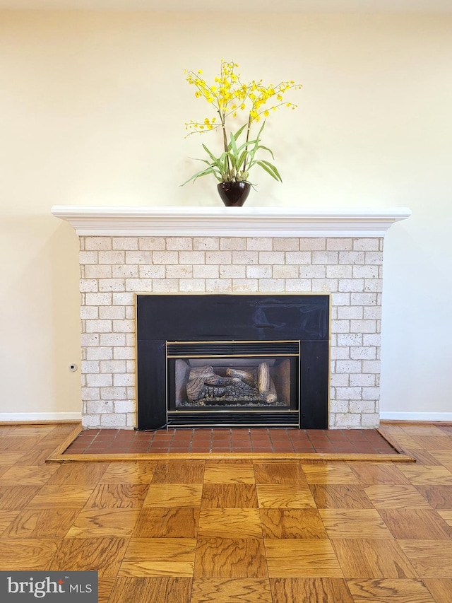 details featuring a fireplace and baseboards