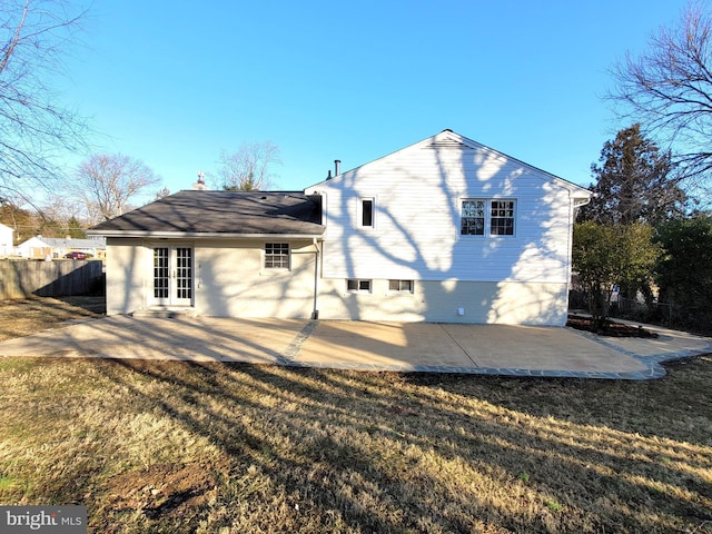 back of house featuring french doors, a yard, a chimney, a patio, and fence