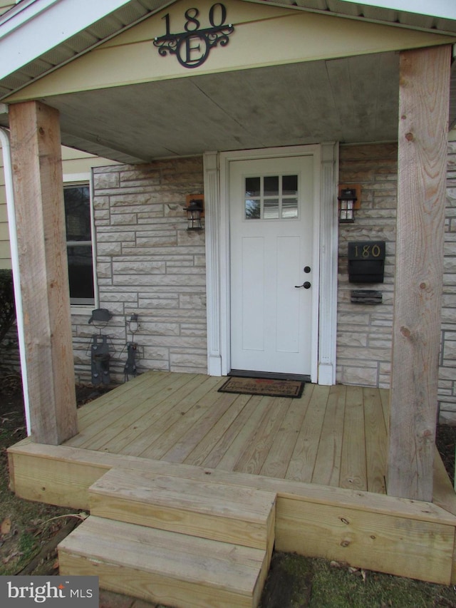 property entrance with stone siding