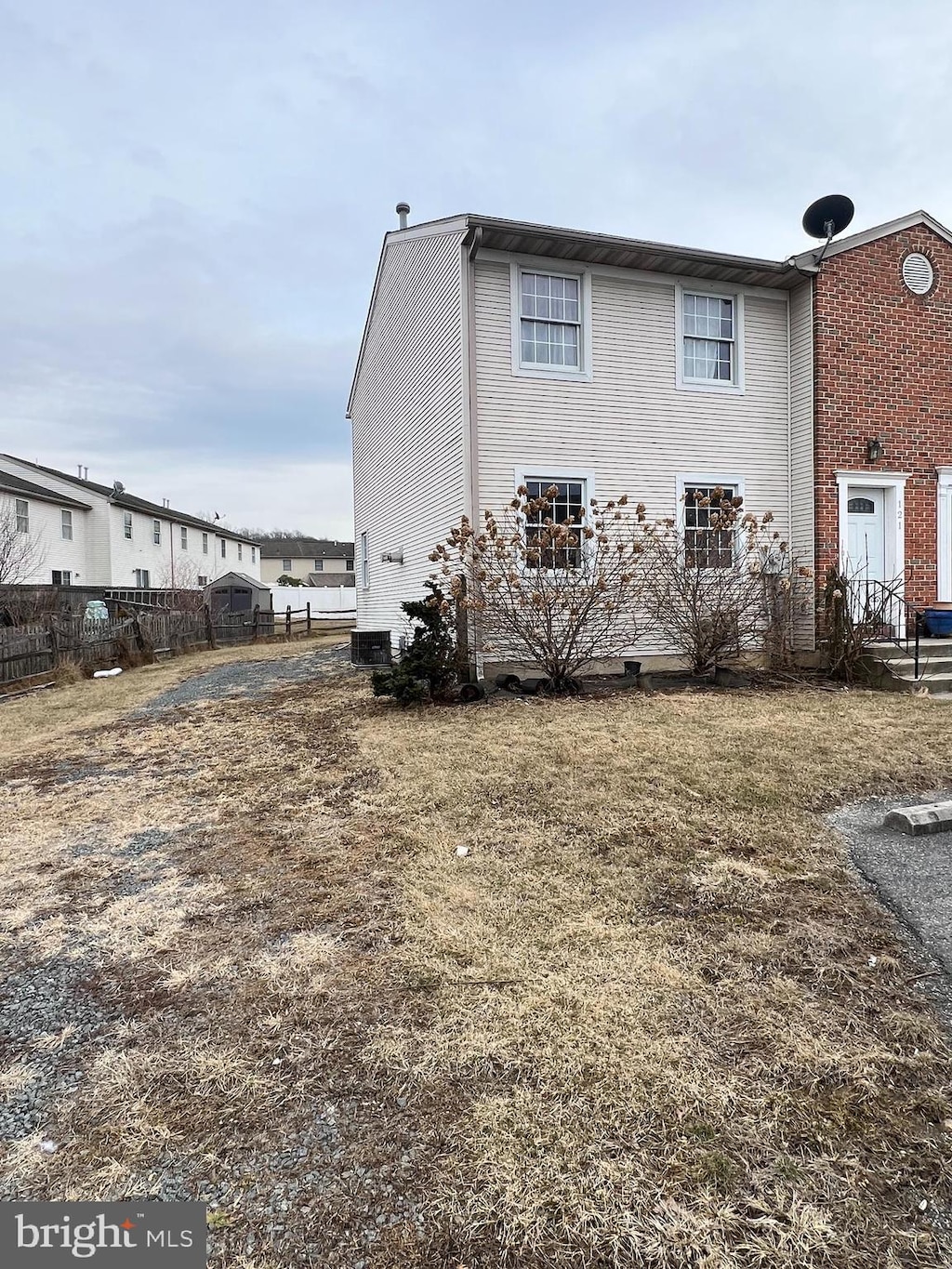 view of home's exterior with cooling unit and fence