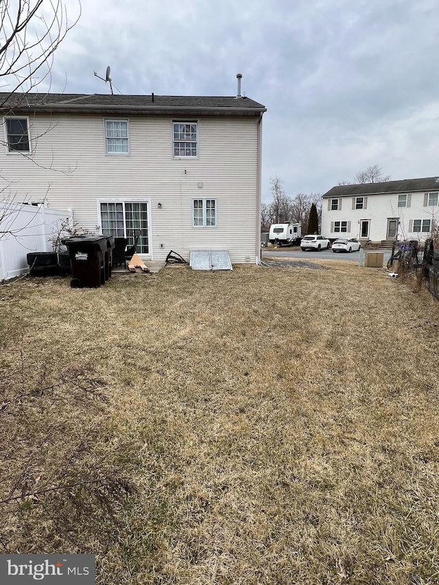 back of property with a lawn