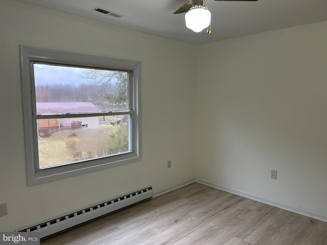 empty room featuring light wood finished floors, visible vents, baseboards, a baseboard radiator, and ceiling fan