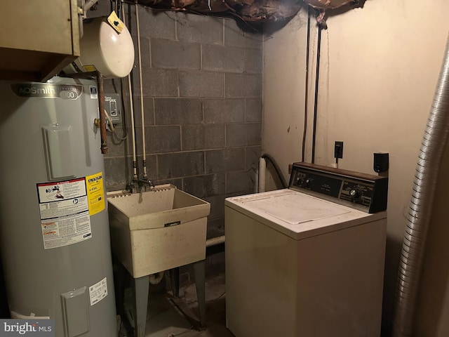 washroom with washer / dryer, water heater, laundry area, and a sink