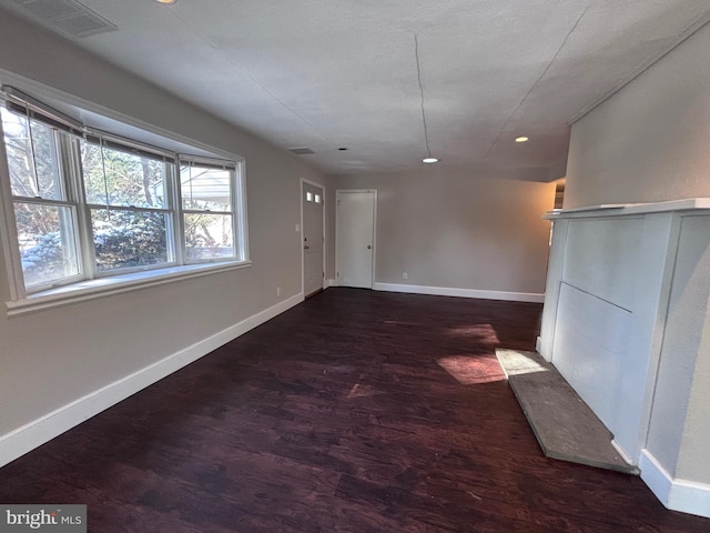 interior space featuring recessed lighting, wood finished floors, visible vents, and baseboards