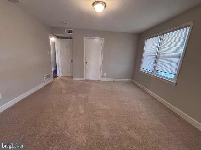 unfurnished bedroom featuring baseboards, visible vents, and carpet flooring