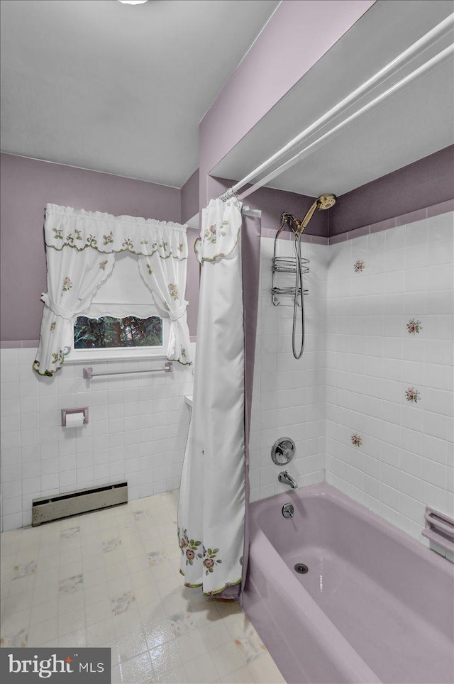 full bath with a baseboard heating unit, wainscoting, shower / bath combination with curtain, and tile walls