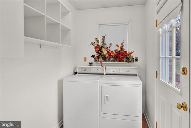 laundry area with washer and dryer, laundry area, and baseboards