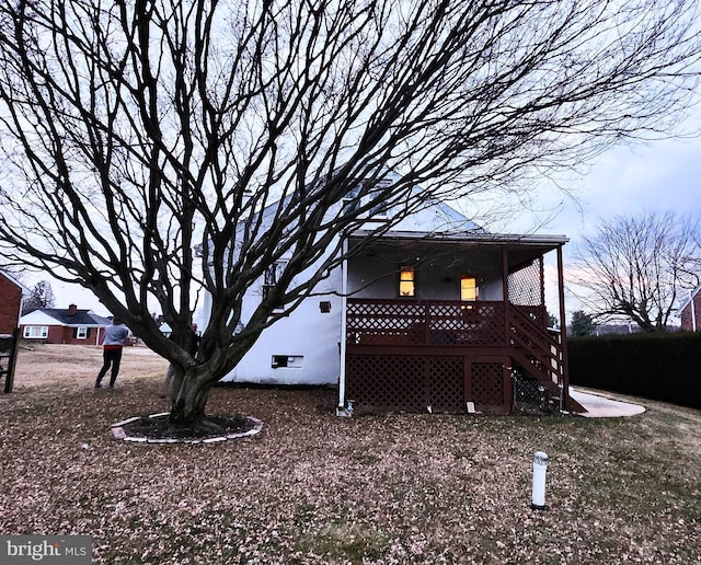 view of side of property featuring stairway