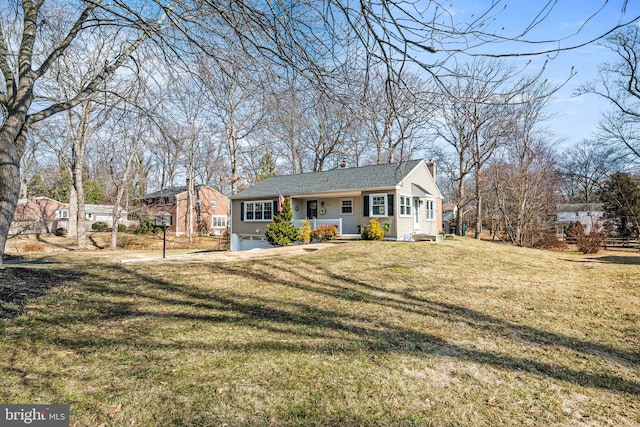 single story home featuring a garage, a front yard, covered porch, and a chimney