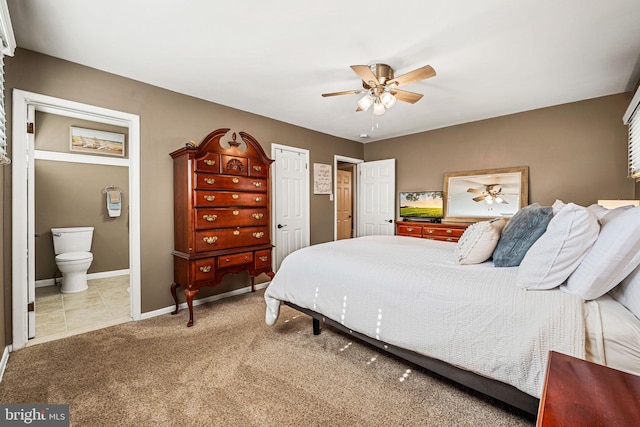 bedroom featuring ceiling fan, connected bathroom, tile patterned flooring, baseboards, and carpet